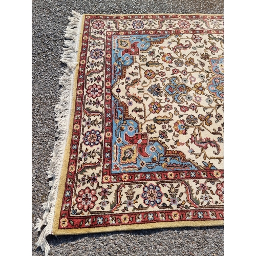 1656 - A Persian rug, having central flower medallion, with floral cartouches to each corner, with floral b... 