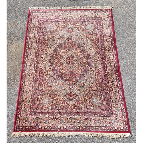 1660 - A large Persian rug, having central floral medallion, with floral borders, 305 x 205cm.... 