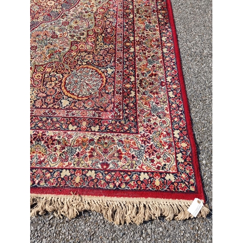 1660 - A large Persian rug, having central floral medallion, with floral borders, 305 x 205cm.... 