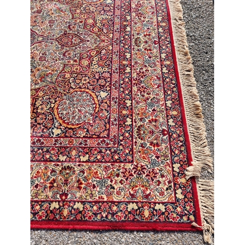 1660 - A large Persian rug, having central floral medallion, with floral borders, 305 x 205cm.... 