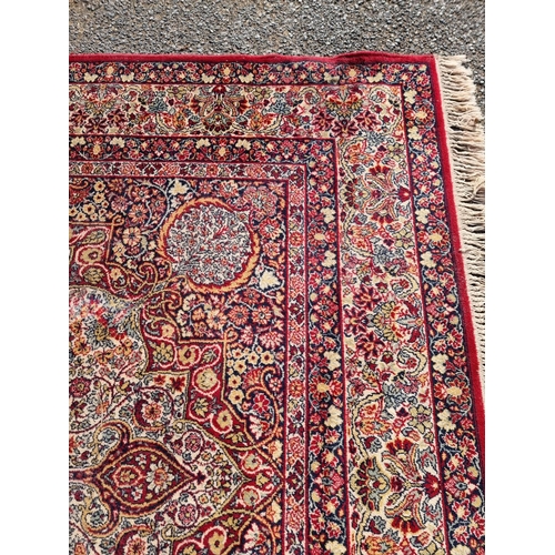 1660 - A large Persian rug, having central floral medallion, with floral borders, 305 x 205cm.... 