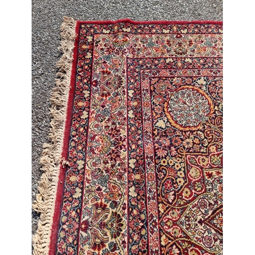 1660 - A large Persian rug, having central floral medallion, with floral borders, 305 x 205cm.... 