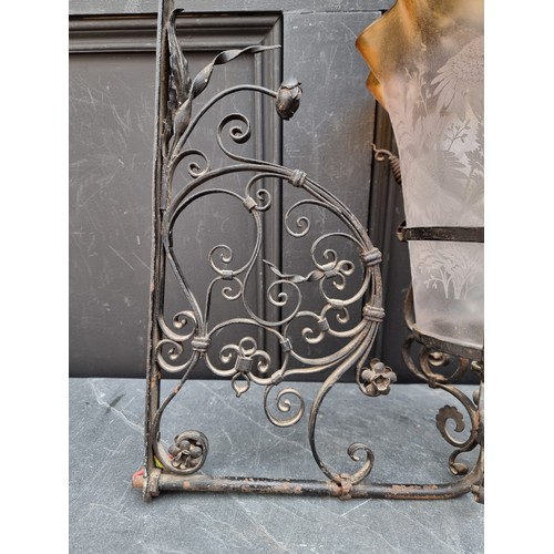 1628A - A wrought iron or steel wall light bracket, with etched glass shade, 43cm high x 40cm deep.... 