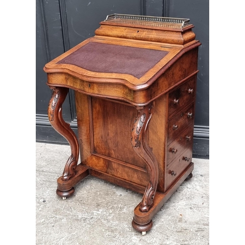 1064 - A Victorian walnut Davenport, 54.5cm wide.