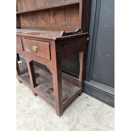 1000 - An 18th century oak 'Dog Kennel' dresser and rack, 152.5cm wide.