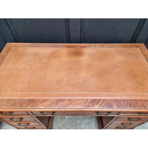 1003 - A reproduction mahogany pedestal desk, 121.5cm wide.