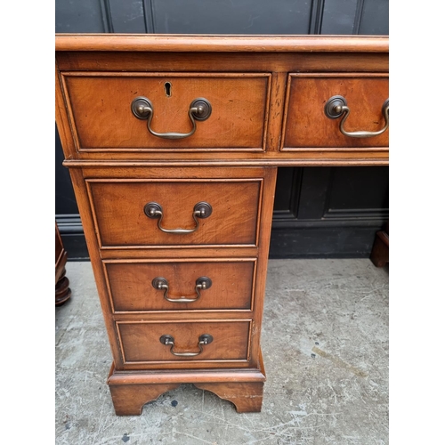 1003 - A reproduction mahogany pedestal desk, 121.5cm wide.