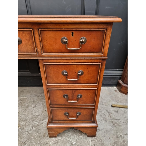 1003 - A reproduction mahogany pedestal desk, 121.5cm wide.