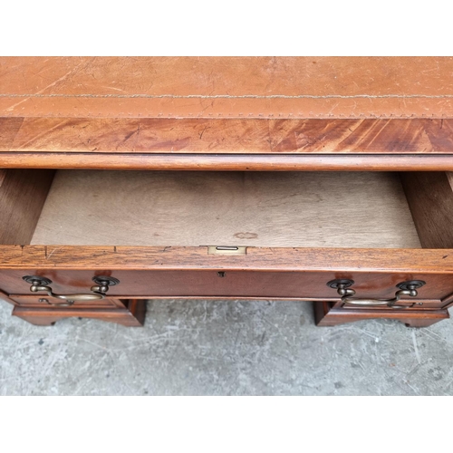 1003 - A reproduction mahogany pedestal desk, 121.5cm wide.