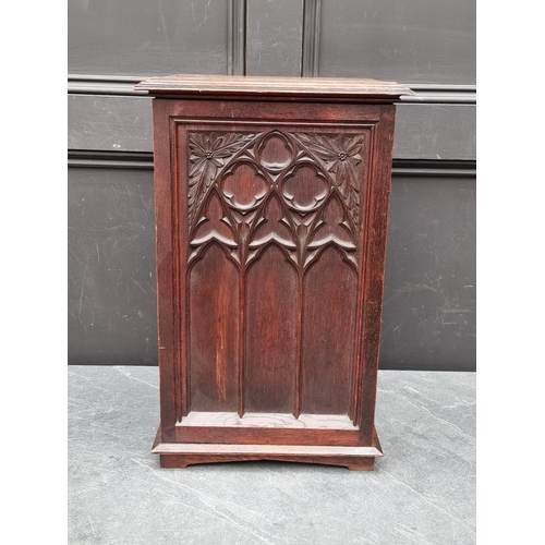 1014 - A small Gothic oak cupboard, opening to reveal drawers and pigeon holes, 53.5cm high x 33.5cm wide.... 