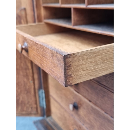 1014 - A small Gothic oak cupboard, opening to reveal drawers and pigeon holes, 53.5cm high x 33.5cm wide.... 