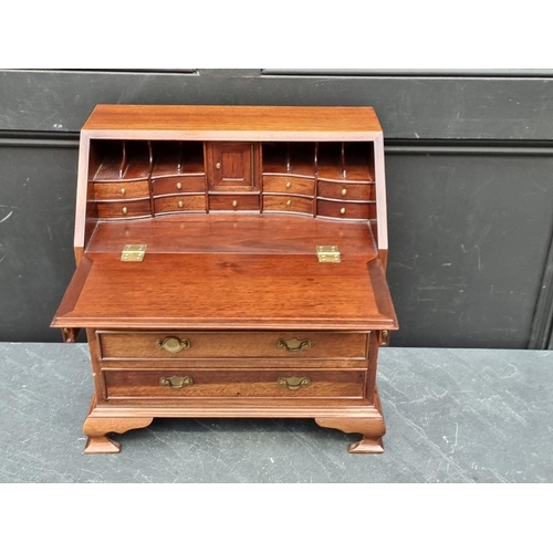 1017 - A miniature reproduction mahogany bureau, 45.5cm high x 41cm wide.