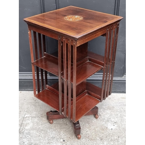 1019 - An Edwardian mahogany and inlaid revolving bookcase, 46.5cm wide, (faults).