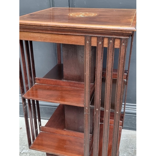 1019 - An Edwardian mahogany and inlaid revolving bookcase, 46.5cm wide, (faults).