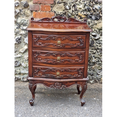 1022 - A small reproduction carved mahogany chest of drawers, 60cm wide.