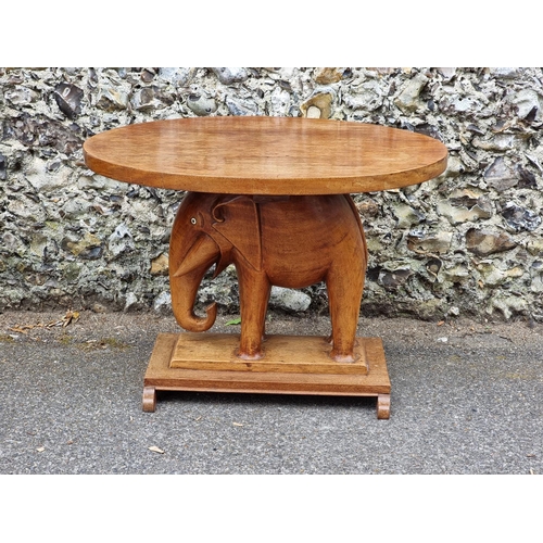 1023 - An Eastern teak elephant table, with ivory inset eyes, 82cm wide. DEFRA Ivory Act submission ref: GV... 