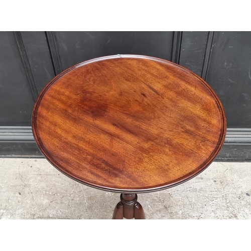 1044 - An antique mahogany and oak circular tripod table, 52cm diameter.