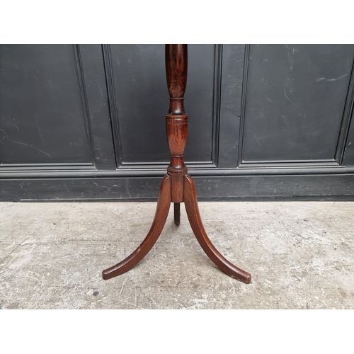 1044 - An antique mahogany and oak circular tripod table, 52cm diameter.