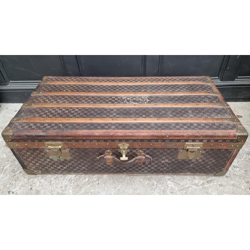 1048 - A late 19th/early 20th century Moynat 'Damier' trunk, labelled to the interior, 34cm high x 110.5cm ... 