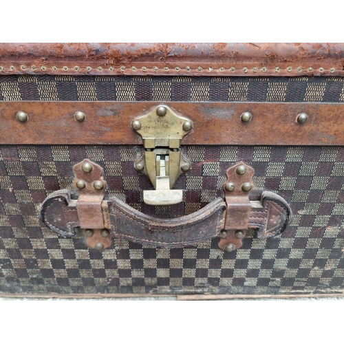 1048 - A late 19th/early 20th century Moynat 'Damier' trunk, labelled to the interior, 34cm high x 110.5cm ... 