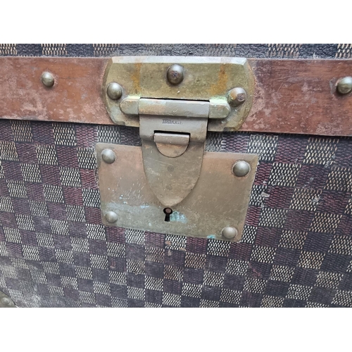 1048 - A late 19th/early 20th century Moynat 'Damier' trunk, labelled to the interior, 34cm high x 110.5cm ... 