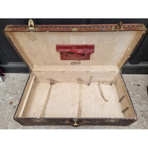 1048 - A late 19th/early 20th century Moynat 'Damier' trunk, labelled to the interior, 34cm high x 110.5cm ... 