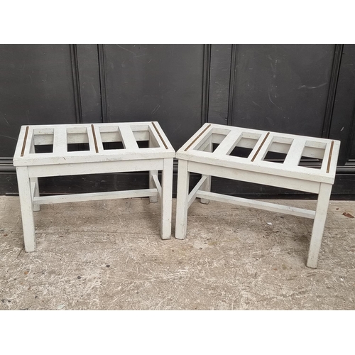 1050 - A pair of grey painted luggage stands, 61cm wide.