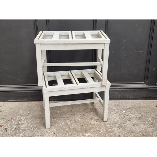 1050 - A pair of grey painted luggage stands, 61cm wide.