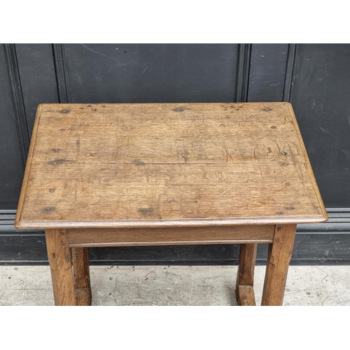 1054 - A small 18th century oak centre table, with chamfered legs, 63cm wide.