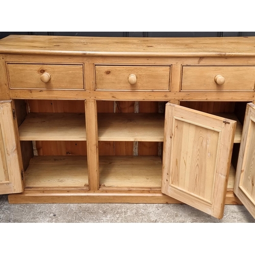 1055 - An old pine side cabinet, 152.5cm wide.