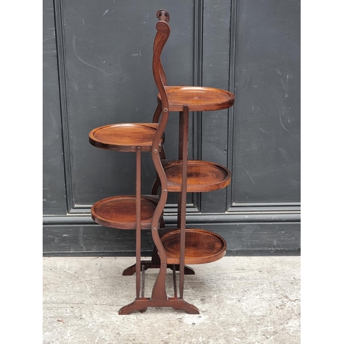 1058 - An early 20th century mahogany five-tier folding cake stand.