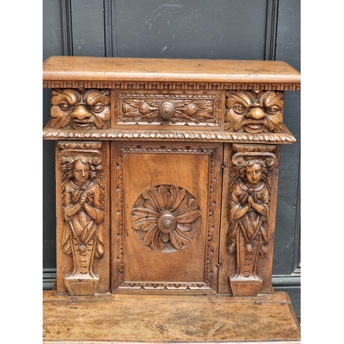 1061 - A 17th century and later Italian carved walnut prie dieu, 71cm wide.