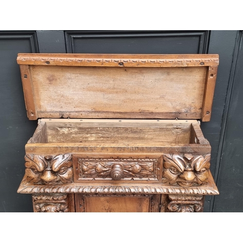 1061 - A 17th century and later Italian carved walnut prie dieu, 71cm wide.