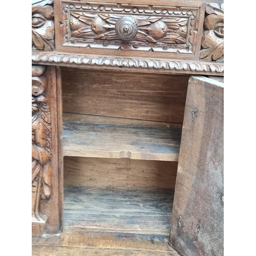 1061 - A 17th century and later Italian carved walnut prie dieu, 71cm wide.