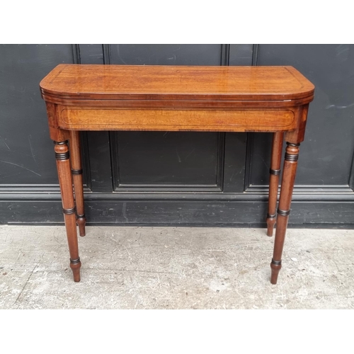 1066 - A George IV mahogany, line inlaid and crossbanded card table, with double gateleg, 91cm wide.... 