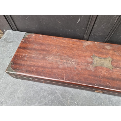 1075 - A Victorian mahogany and brass bound shotgun case, 83cm wide, (crack to top).