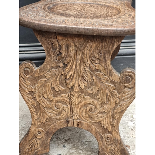 1079 - A pair of 17th century style carved oak 'Green Man' hall chairs.