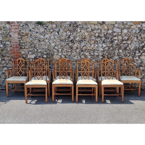 1080 - An unusual set of ten carved beech dining chairs, to include a pair of elbow chairs, in the Chinese ... 