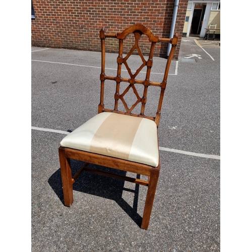 1080 - An unusual set of ten carved beech dining chairs, to include a pair of elbow chairs, in the Chinese ... 