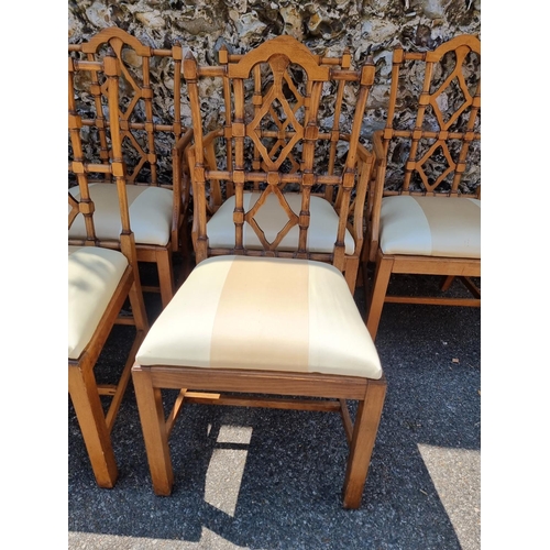 1080 - An unusual set of ten carved beech dining chairs, to include a pair of elbow chairs, in the Chinese ... 