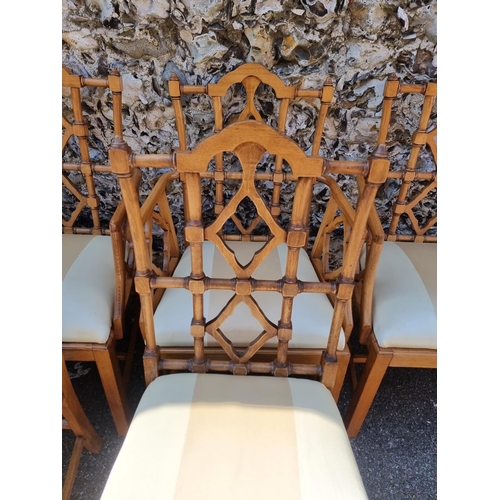 1080 - An unusual set of ten carved beech dining chairs, to include a pair of elbow chairs, in the Chinese ... 