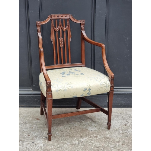 1081 - A George III carved mahogany elbow chair, in the manner of Hepplewhite, (old repairs to front legs).... 