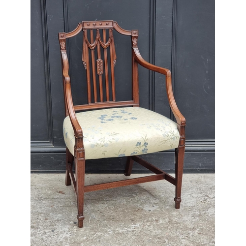 1081 - A George III carved mahogany elbow chair, in the manner of Hepplewhite, (old repairs to front legs).... 