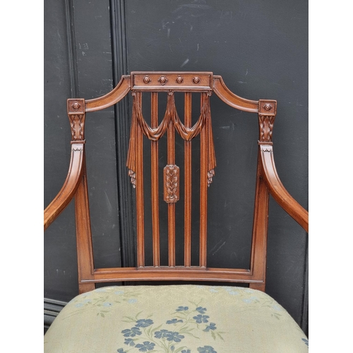 1081 - A George III carved mahogany elbow chair, in the manner of Hepplewhite, (old repairs to front legs).... 