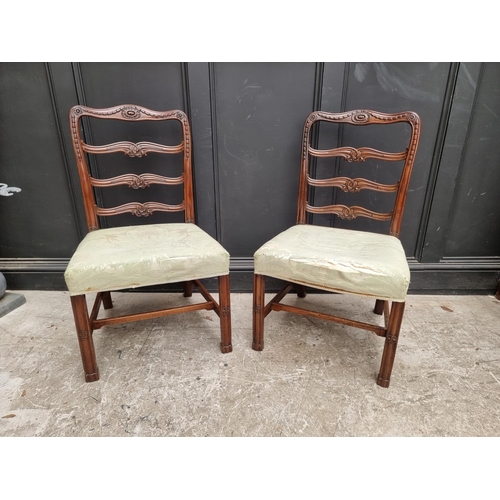 1082 - A pair of George III carved mahogany ladderback dining chairs.