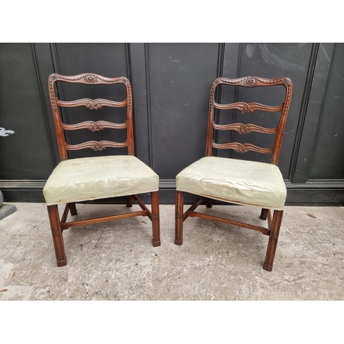 1082 - A pair of George III carved mahogany ladderback dining chairs.