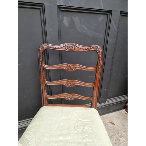 1082 - A pair of George III carved mahogany ladderback dining chairs.