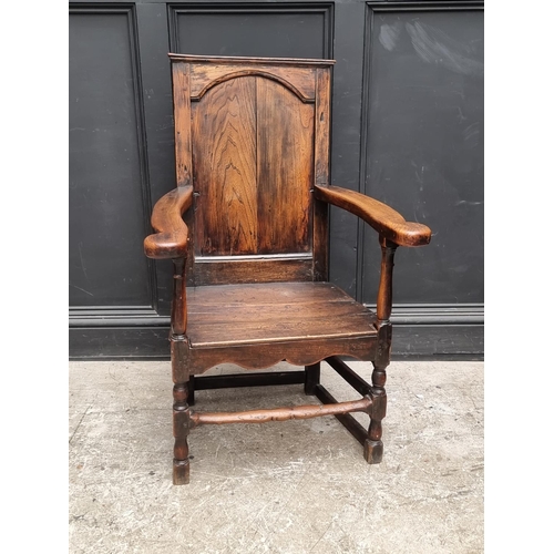 1088 - An 18th century oak panelled open arm elbow chair.