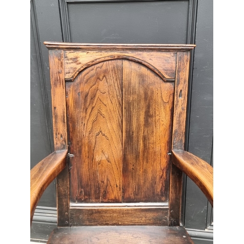 1088 - An 18th century oak panelled open arm elbow chair.