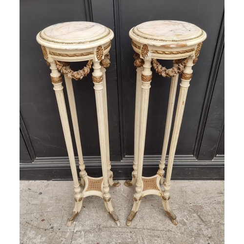 1091 - A pair of Louis XVI style cream painted, parcel gilt and marble top torcheres, 107.5cm high.... 